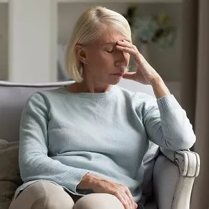 woman stressed with hand over face