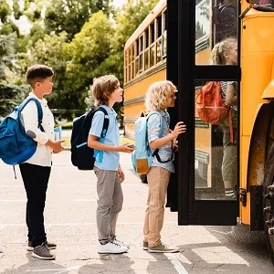 kids getting on a school bus