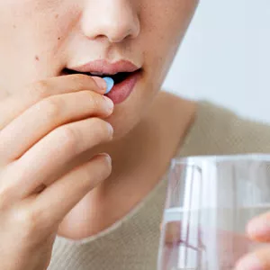 woman taking a pill