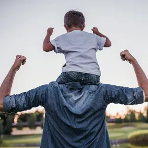 child on dad's back