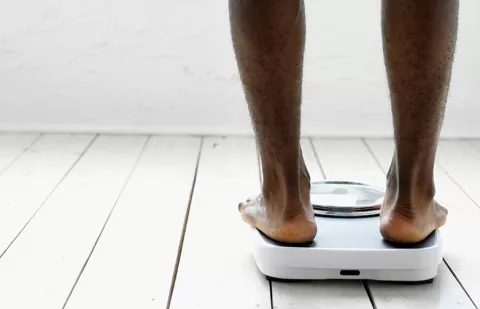 man standing on weight scale. 