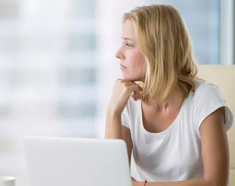 Woman in office looking out of window