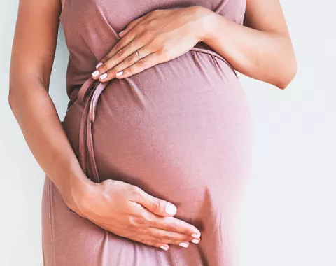 Pregnant woman holding her stomach