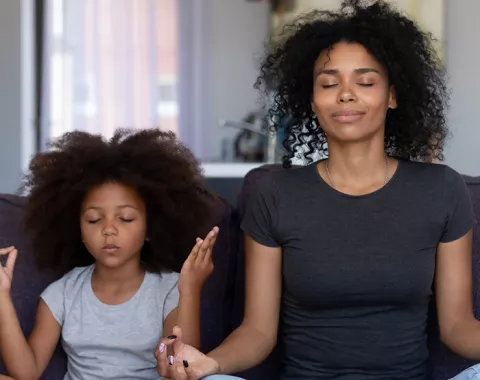 Mom Daughter sitting on couch meditating