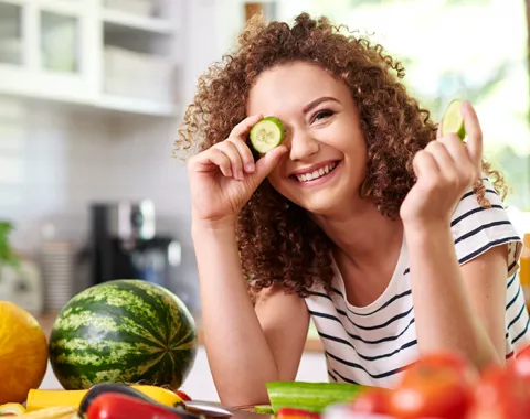 Smiling young woman making food